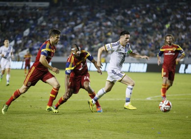 Los Angeles Galaxy's Robbie Keane, second right, takes the ball past Real Salt Lake's Chris Wingert, left.