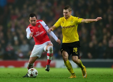 Arsenal's Santi Cazorla (left) and Borussia Dortmund's Lukasz Piszczek in action during the UEFA Champions League match at the Emirates Stadium.