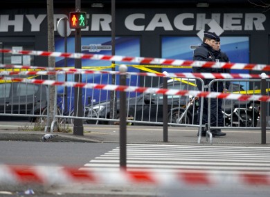 Police stand guard outside the supermarket where Amedy Coulibaly killed four people.