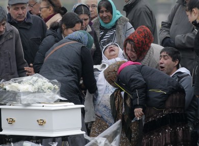 The mother of Maria Francesca, who died of sudden infant death syndrome, cries in front of the coffin of her baby during the funeral in Wissous, outside Paris.