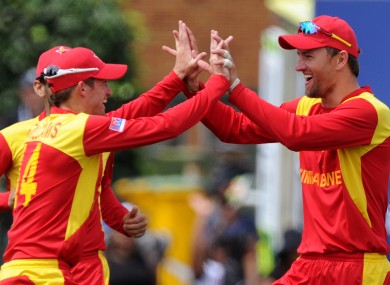 Zimbabwe's Craig Ervine, right, celebrates his catch.
