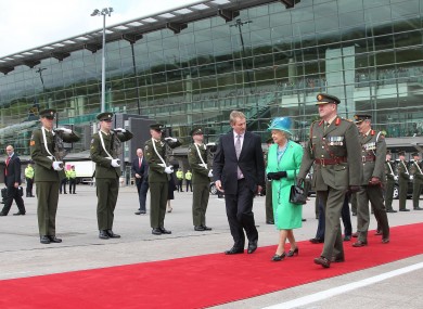 Taoseach Enda Kenny walking alongside the Queen at Cork Airport