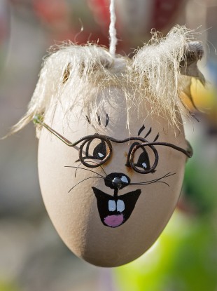 A decorated egg hangs on an apple tree with abut 10,000 painted Easter eggs in the garden of retired couple Christa and Volker Kraft in Saalfeld, central Germany