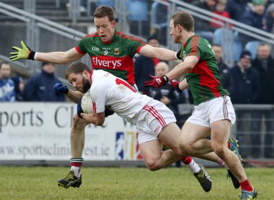 Colm Boyle and Donal Vaughan attempt to tackle Peter Hughes of Tyrone.