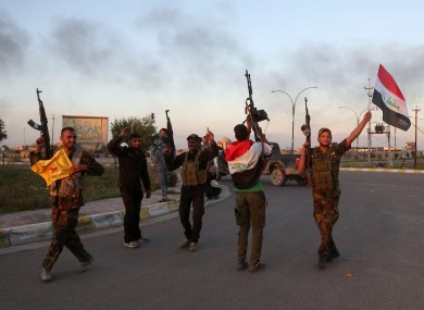 Iraqi security forces and allied Shiite militiamen celebrate in central Tikrit after Islamic State troops were driven out the city late last month.