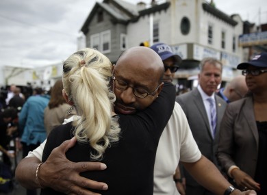 Philadelphia Mayor Michael Nutter consoles a nearby resident