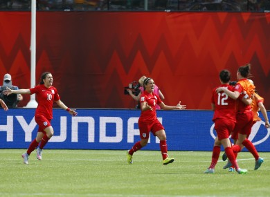 England midfielder Fara Williams celebrates with team-mates.