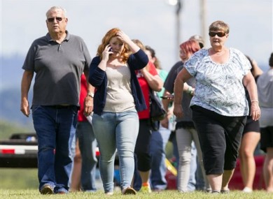 Parents and students leave after reuniting with their children following a