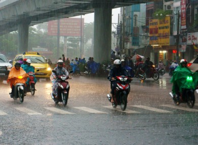 Five motorcyclists in Ho Chi Minh City, Vietnam.