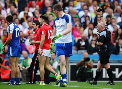 Tiernan McCann is shown a black card by referee Marty Duffy.