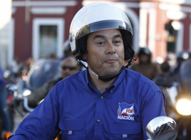 Morales rides his motorcycle prior to a campaign rally earlier this month.