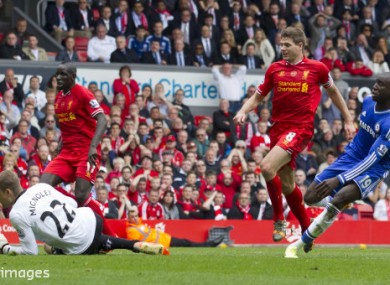 Gerrard watches on as Demba Ba scores the first goal in Chelsea's 2-0 win at Anfield in 2014, which helped cost Liverpool the title.