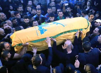 Relatives and friends carry the coffin of Hezbollah member Adel Termos, who was killed in Thursday's twin suicide bombings.