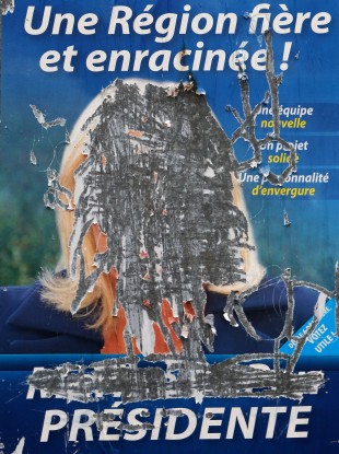 A torn poster of French far-right party leader Marine Le Pen.