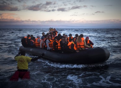 Refugees and migrants arriving on the Greek island of Lesbos yesterday