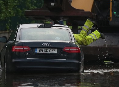 Emergency workers remove a car in the area of Corbally in Limerick yesterday.