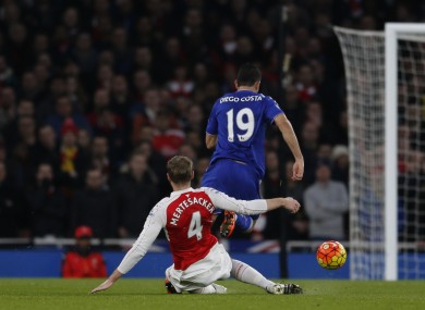 Arsenal's Per Mertesacker tackles and fouls Chelsea's Diego Costa for which he is shown a red card and sent off.