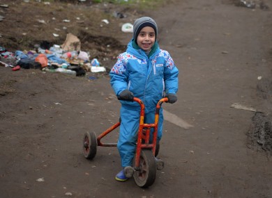 A child on a tricycle pictured in the Jungle refugee camp earlier this month.