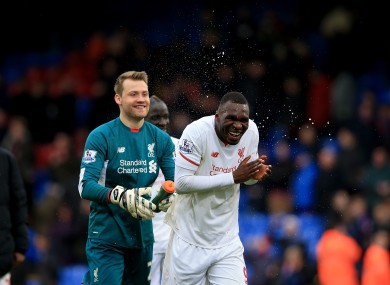 Simon Mignolet sprays Liverpool's Christian Benteke after the final whistle.