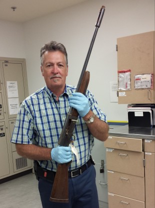 Detective Michael Ciesynski holds the shotgun which rock legend Kurt Cobain used to take his own life in 1994.