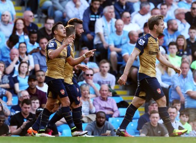 Alexis Sanchez (left) celebrates the goal that could cost City a fortune.
