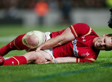 Wales wing George North clutches his injured hamstring