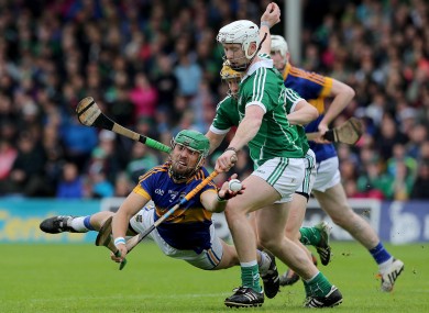Tipperary's James Barry grabs the sliothar under pressure from Limerick's Cian Lynch.