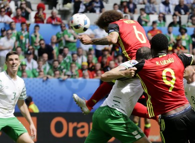 Belgium's Axel Witsel, top, scores on a header his side's second goal.