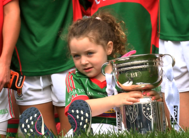 A young supporter gets her hands on the trophy.
