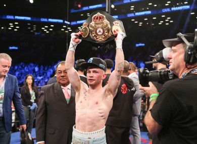 Carl Frampton holds up his championship belt after his WBA Super World Featherweight Championship fight against Leo Santa Cruz at the Barclays Center in the Brooklyn borough of New York on Saturday.