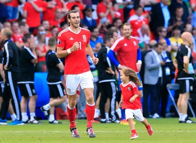 Wales' Gareth Bale and his daughter Alba Violet on the pitch after the final whistle against Northern Ireland.