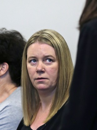 Aisling Brady McCarthy, left, listens to her attorney prior to a status hearing at Middlesex Superior Court last year.