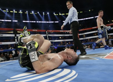 Liam Smith, left, lays on the mat after being knocked out by Canelo Alvarez fight during the ninth round.
