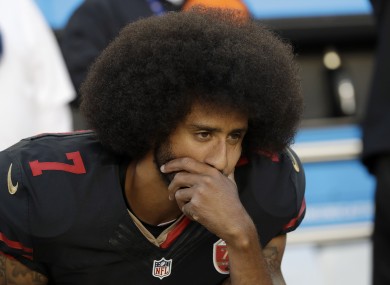 San Francisco 49ers quarterback Colin Kaepernick (7) kneels during the national anthem before an NFL football game against the Arizona Cardinals.