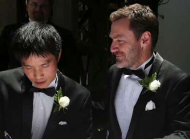 Ian Hinton, right, watches his partner Chris Teoh sign their wedding register in Canberra on 7 December 2013. The High Court overruled the state's law a few days later.