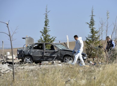 Police forensic officers work at the scene after suicide bombers blew themselves up in Haymana.