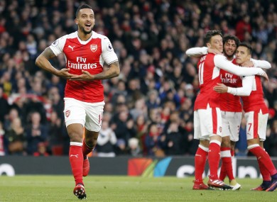 Arsenal's Theo Walcott, left, celebrates after scoring.