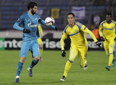 Luis Neto of Zenit St.Petersburg , left, struggles for a ball with Ezequiel Scarione of Maccabi Tel-Aviv.