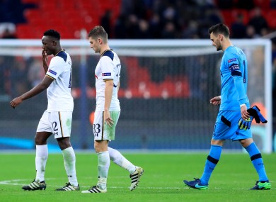The Spurs players trudge off the pitch.