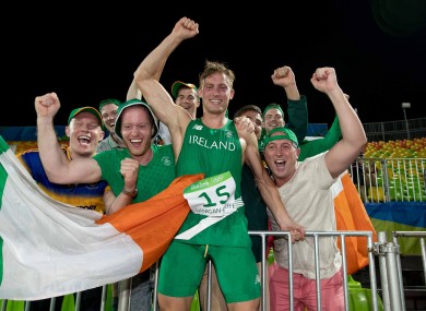 Ireland's Arthur Lanigan-O'Keeffe celebrates his eighth-placed finish with supporters.
