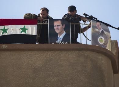 File photo of Syrian soldiers keeping watch in a town on the northern outskirts of Damascus.