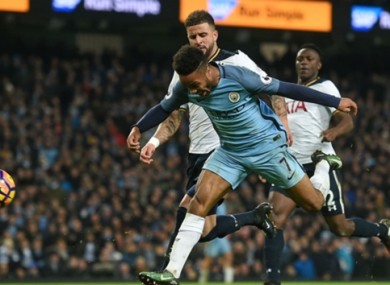 Man City's Raheem Sterling is impeded by Kyle Walker of Tottenham.