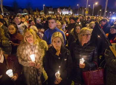 Mourners attend a vigil at the former site of the Andersontown Police Station in Belfast.
