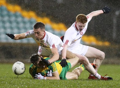 Donegal's Michael Carroll with Tyrone's Paul Donaghey and Nathan Donnelly.