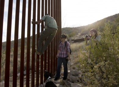 Tim Foley shows how to climb a section of the border wall separating Mexico and the United States.