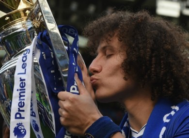 David Luiz celebrates with the Premier League trophy.