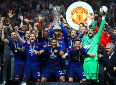 Wayne Rooney lifts the trophy alongside his team-mates.