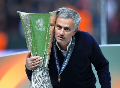 Manchester United manager Jose Mourinho celebrates with the trophy.