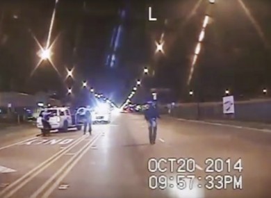 In this screenshot taken from a police dash-cam video, Laquan McDonald, right, walks down the street moments before being fatally shot.
