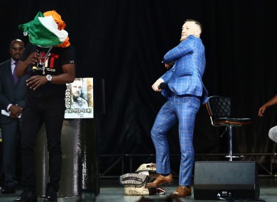 McGregor throws the Irish flag at Mayweather.